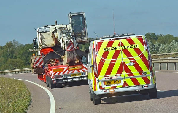 Doherty Escort vehicle on duty supporting an abonormal load towards London